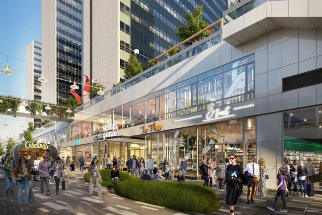 Gata med butiker, höga byggnader och människor som går.